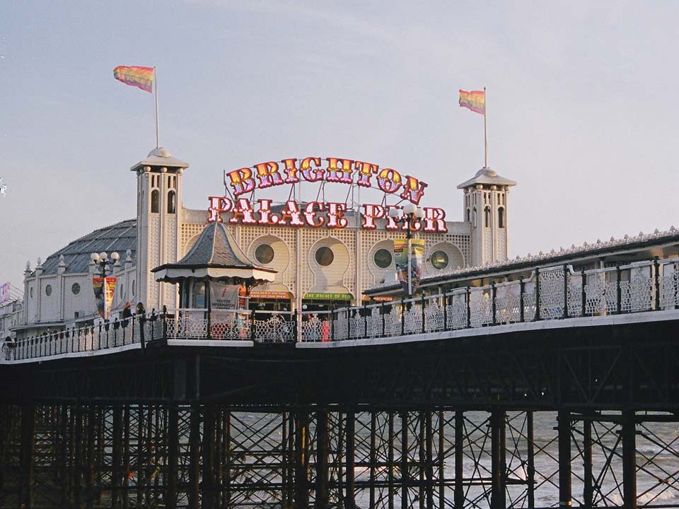 Pride flags flying at the entrance to Brighton Pier.