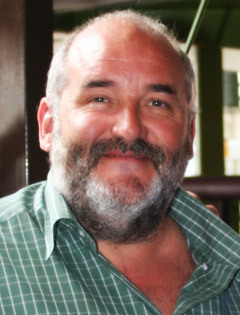 James Ledward, a big, gentle-looking man in a relaxed shirt, with a balding head and a grey beard.