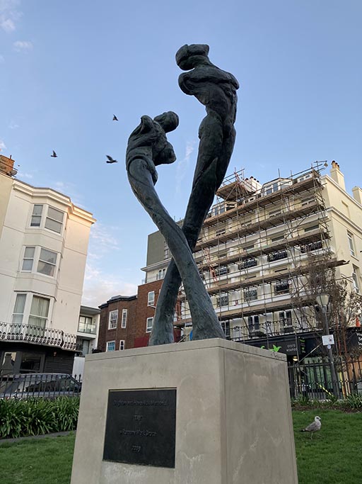 The Brighton AIDS Memorial - Tay. Two androgenous figures soar in the shape of the Red Ribbon.